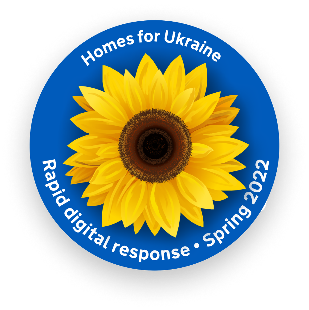 A sticker celebrating the work of the Homes for Ukraine rapid response digital team in 2022. It is in Ukraine's national colours with a sunflower, the national flower, at the center